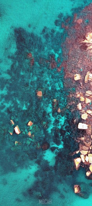 Aerial view of turquoise water with rocks