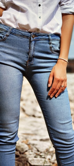 Woman in white shirt and blue jeans