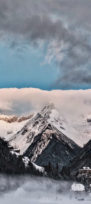 Snowy mountains with clouds and buildings