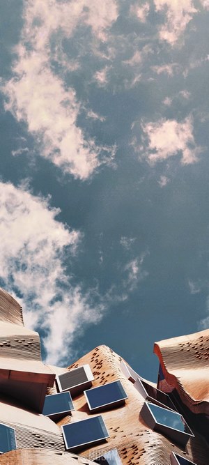 Modern architecture with windows against a cloudy sky