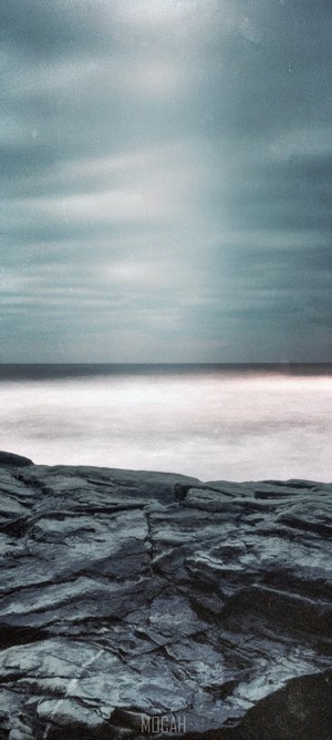Ocean waves crashing on rocky shore