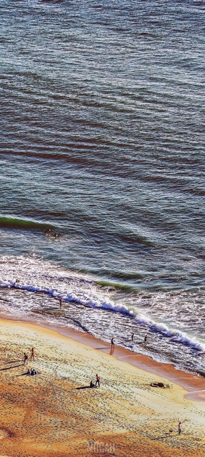 People on a beach near Nazaré, Portugal
