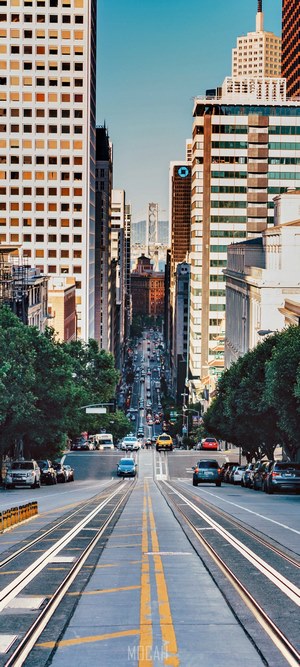 San Francisco street with cable car tracks and skyscrapers
