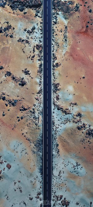 Aerial view of a road through a rocky, colorful landscape