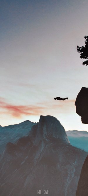 Man base jumping from a cliff at Yosemite