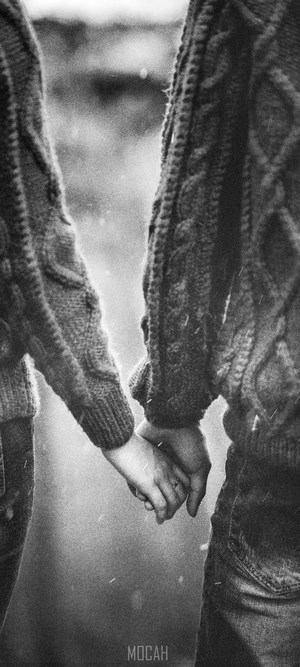 Couple holding hands in sweaters