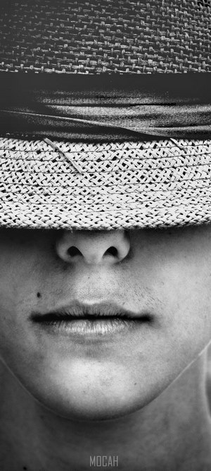 Close-up of a person wearing a straw hat