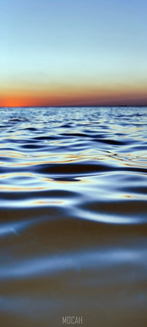Water ripples on the sea at sunset