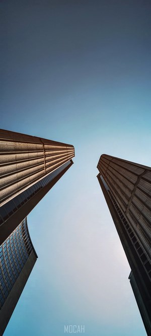 Two skyscrapers against a clear blue sky