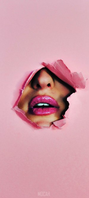 Woman's lips and nose peeking through pink paper