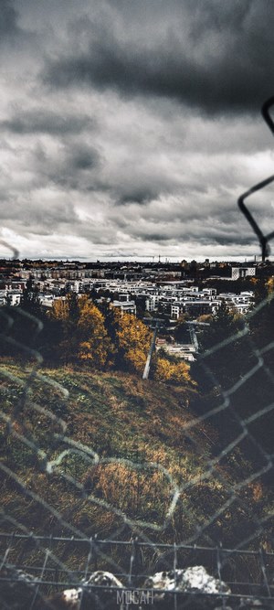 Moody Stockholm cityscape through a fence