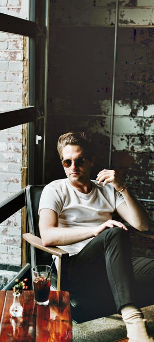 Man in sunglasses sitting in a coffee shop