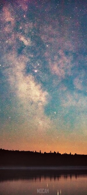 Milky Way over a forest and lake
