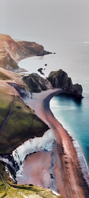 Aerial view of a dramatic coastline with cliffs and a beach