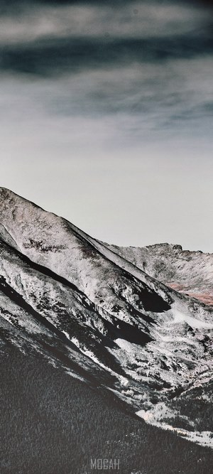 Snowy mountain landscape under a cloudy sky