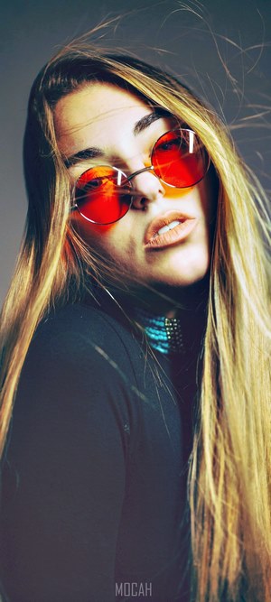 Woman with red sunglasses and blonde hair