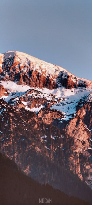 Snow-covered mountain face at sunset