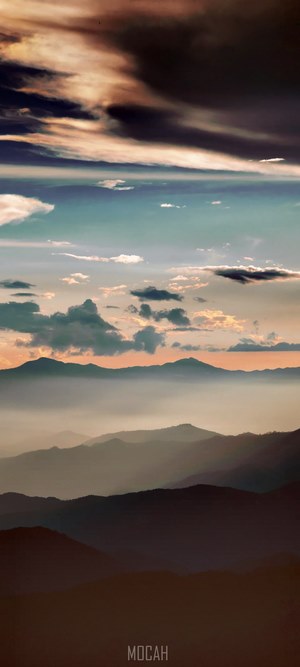 Mountain range at sunset with clouds