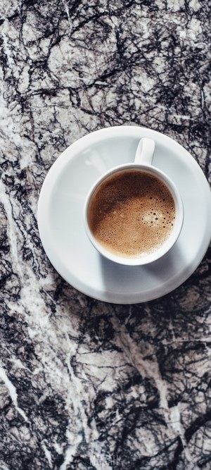 Coffee cup and saucer on marble