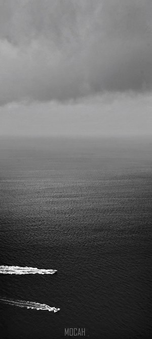 Two boats on the dark sea under a cloudy sky
