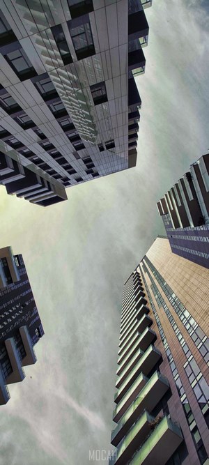 Modern skyscrapers viewed from below against a cloudy sky