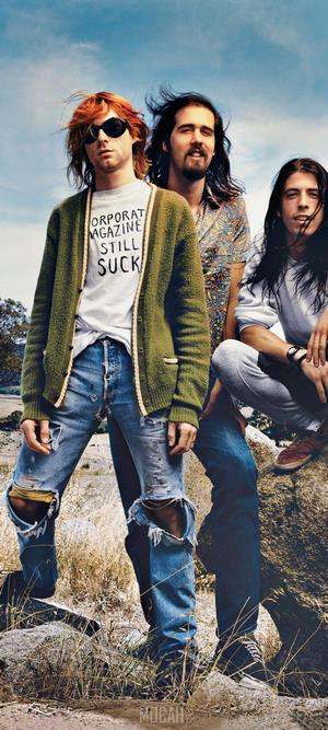 Nirvana band members in ripped jeans and cardigans
