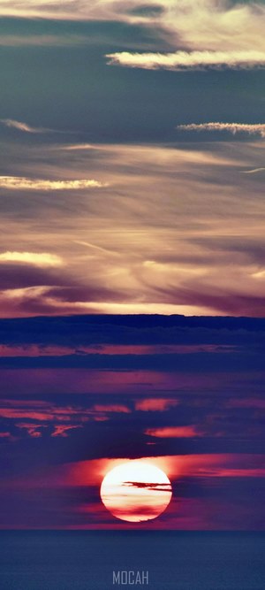 Sunset over the ocean with colorful clouds