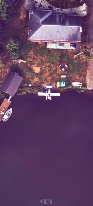 Seaplane and boat at a lake house