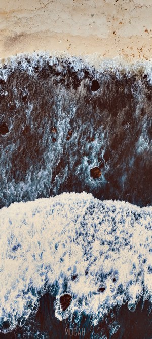 Aerial view of waves crashing on a rocky shore