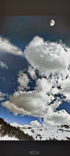 Moon and Clouds over Snowy Mountains