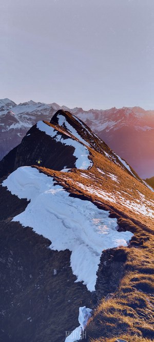 Snow-topped ridge of Augstmatthorn mountain with a person