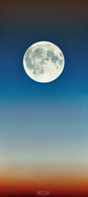 Full moon over a gradient sky with sunset colors
