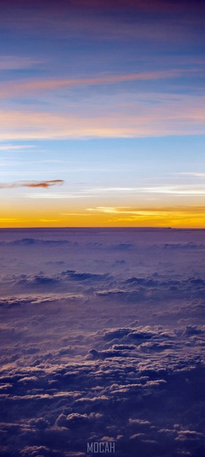 Sunset over clouds from airplane window