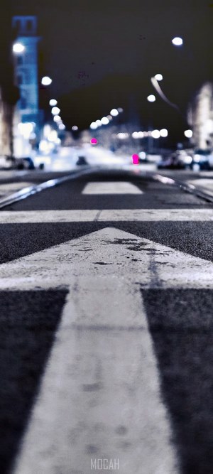 White arrow on asphalt road at night