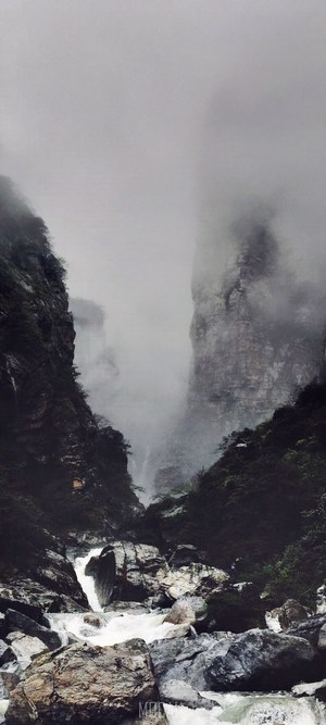 Misty River Valley Between Steep Mountains