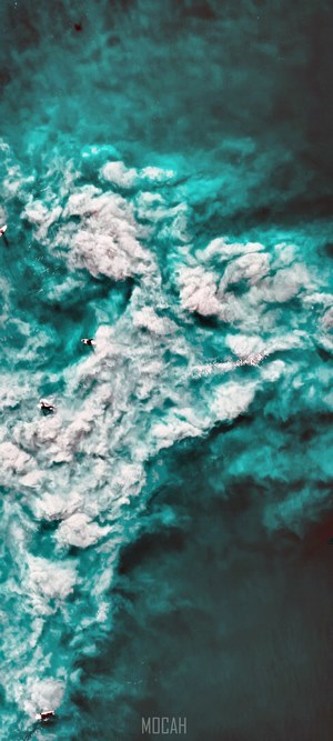 Surfers in turquoise ocean waves
