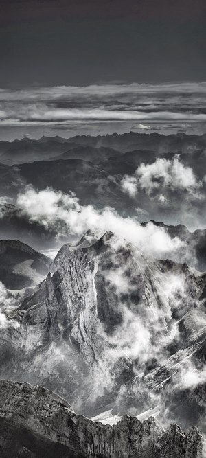 Dramatic mountain peaks shrouded in clouds