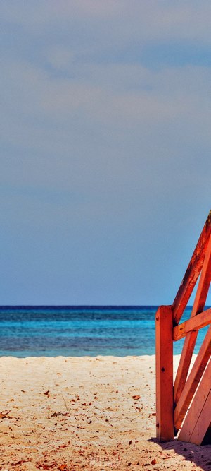 Wooden stairs on a sandy beach by the ocean