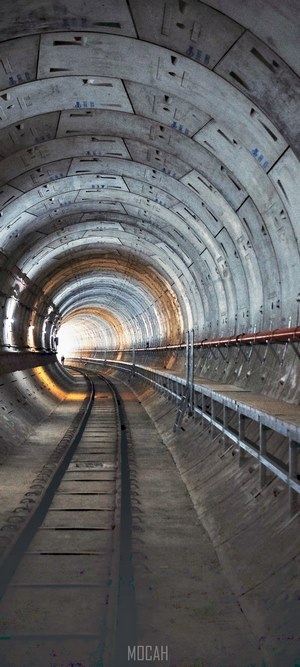 Tunnel with railroad tracks and lighting