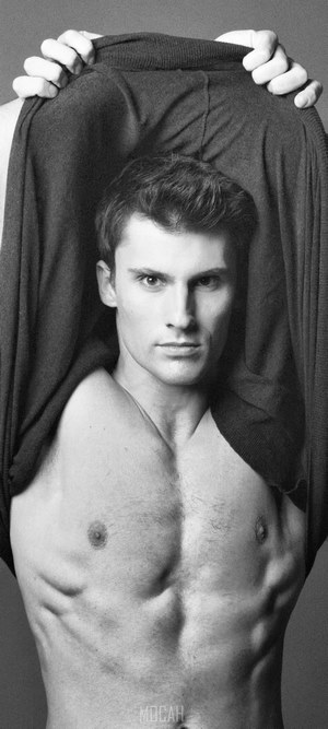 Man pulling off shirt, showing chest