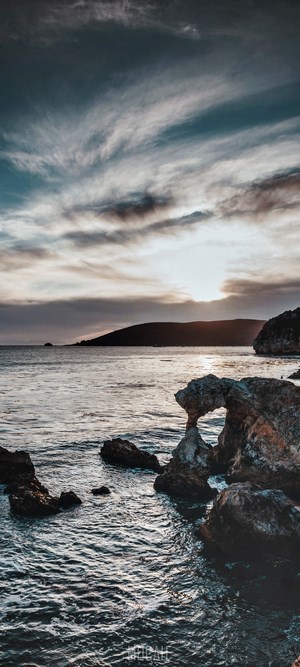 Rocky Coastline at Sunset with Dramatic Clouds