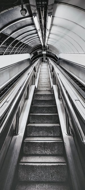 Empty escalator and stairs in a London tunnel