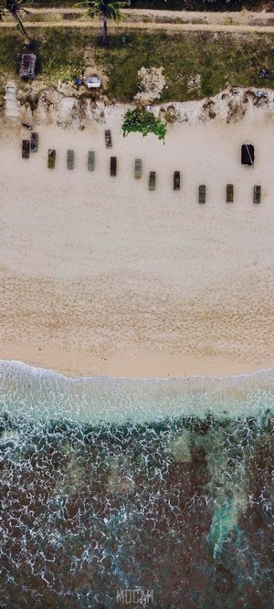 Aerial view of Balangan Beach, Bali with lounge chairs