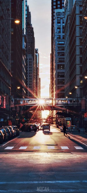 Sunset over downtown Chicago street with elevated train