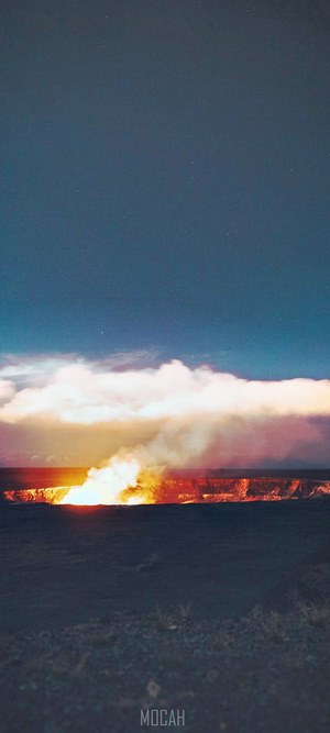 Volcanic eruption at night under starry sky