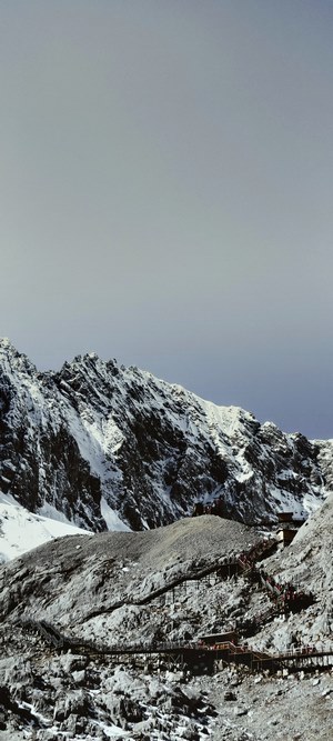 Snowy Yulong Snow Mountain summit with wooden walkway