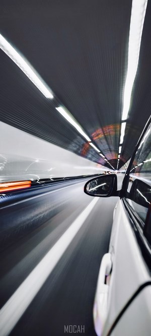 Long exposure photo of a white car in a tunnel
