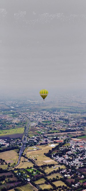 Hot air balloon flying over a city