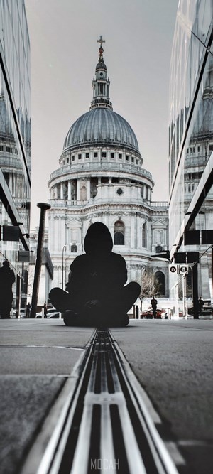 Silhouette meditating in front of St. Paul's Cathedral