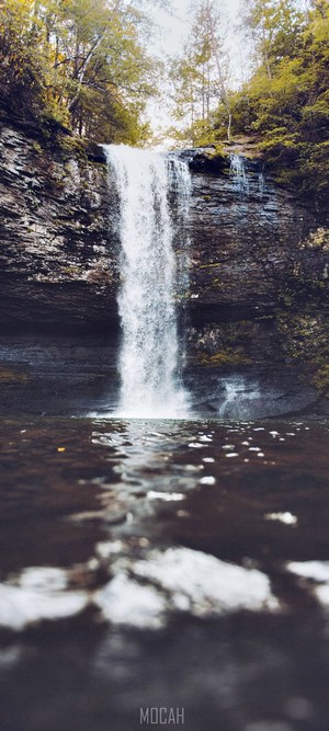 Waterfall cascading over rocky cliff into pool